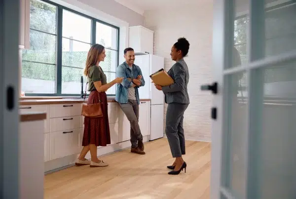 flat fee Real estate agents showing modern kitchen to clients.