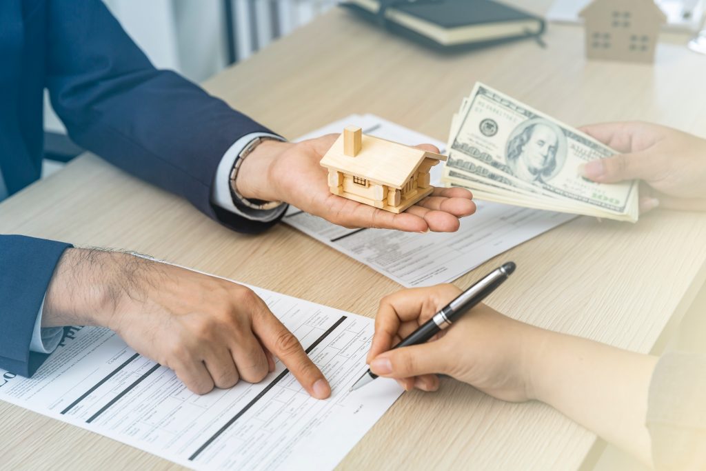 Property exchange with money and contract signing.