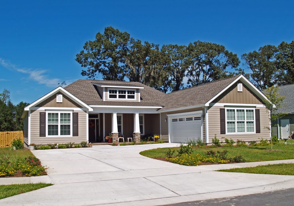 Modern bungalow with driveway and garden.