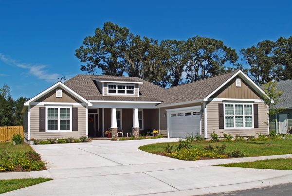 Modern bungalow with driveway and garden.