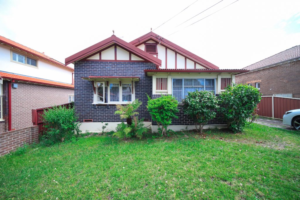 Brick house with front garden and driveway.